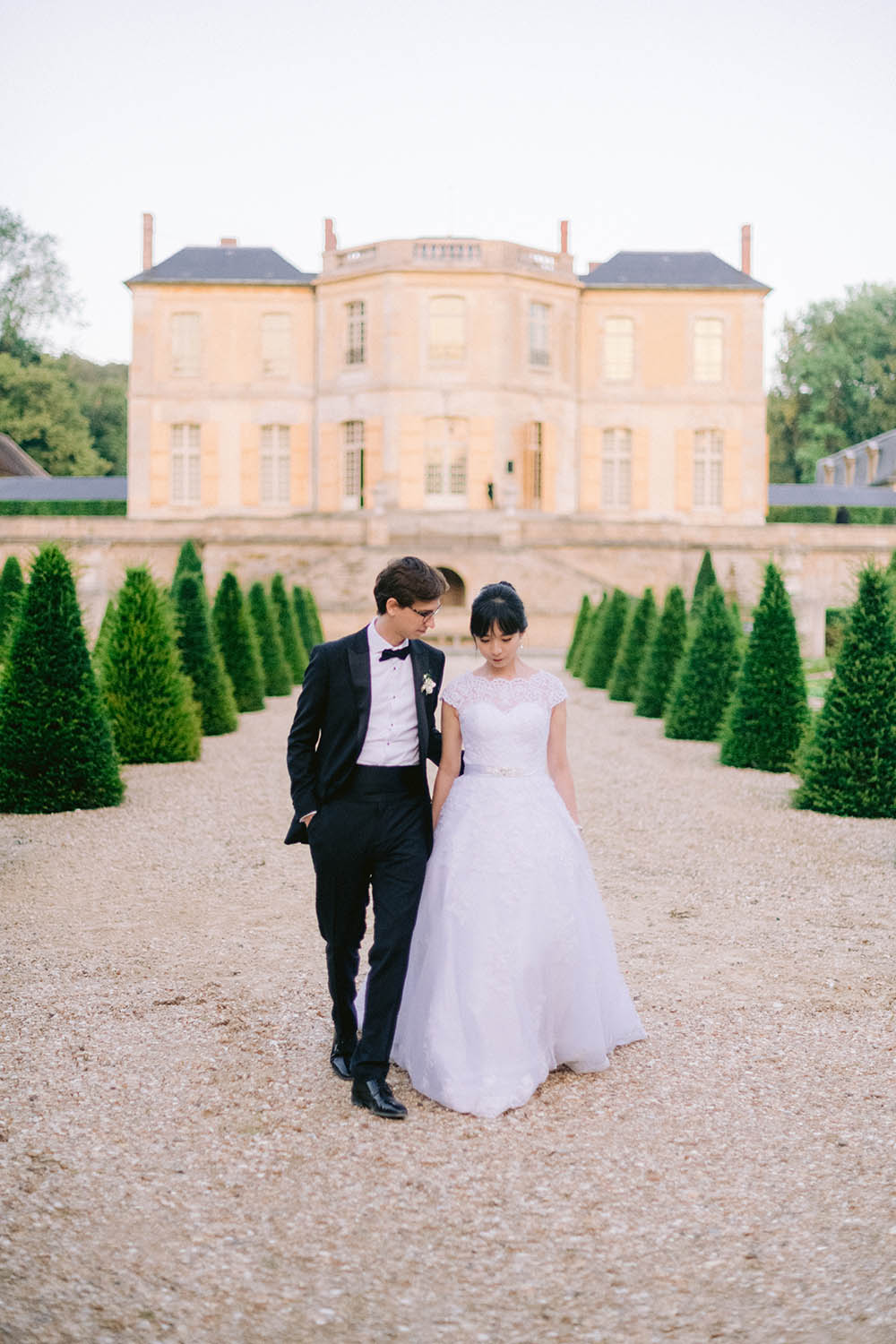 bride and groom walks face the castle